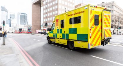 Emergency,Ambulance,Rushing,On,The,Street,With,Emergency,Lights,Flashing