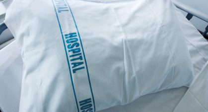 An,Empty,Hospital,Bed,With,The,Word,Hospital,On,A