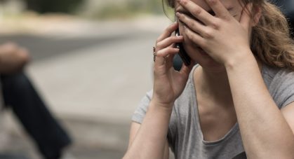 Despair young female driver after traffic accident