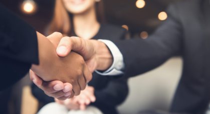 Businessmen,Making,Handshake,With,His,Partner,In,Cafe,-,Business