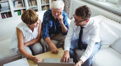 Senior,Couple,Planning,Their,Investments,With,Financial,Advisor,In,Living